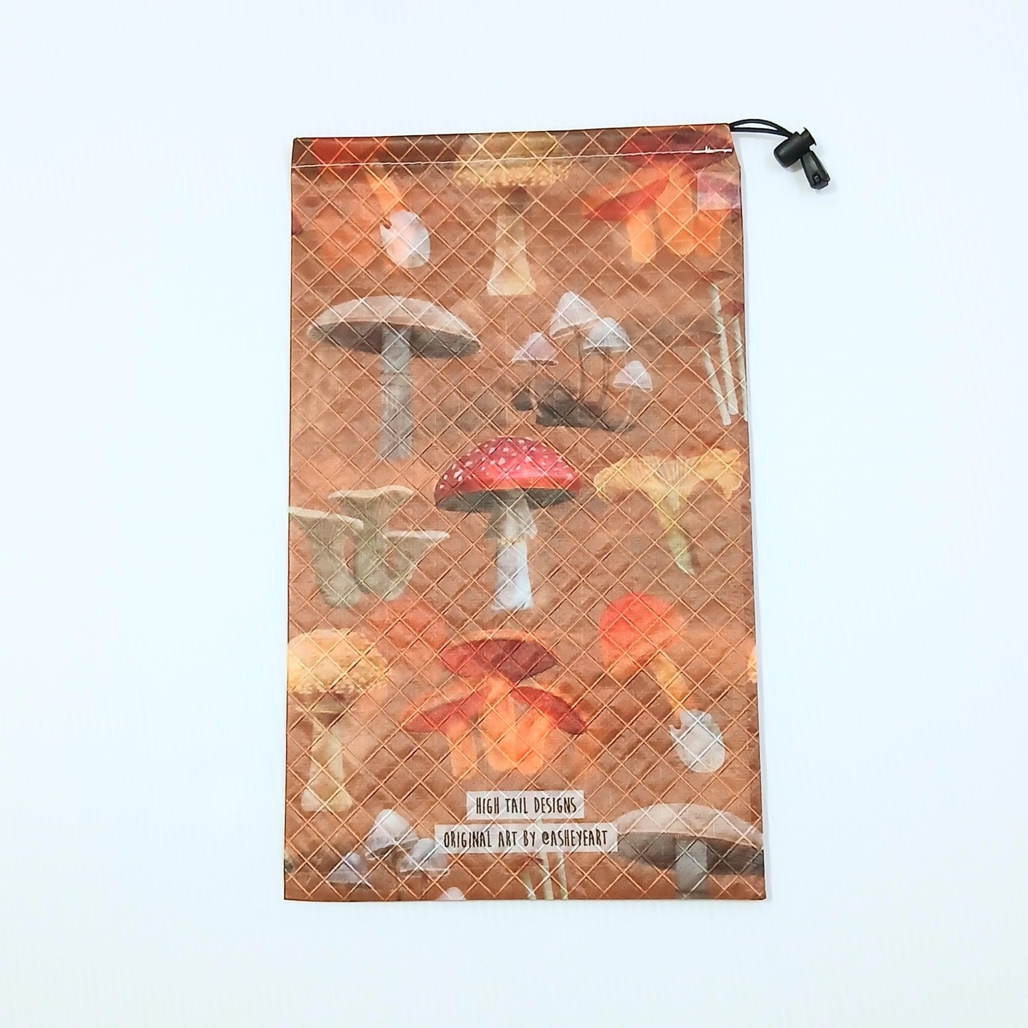 High Tail Designs Ultralight Drawstring Stuff Sack ドローストリングスタッフサック Botany Poster テラコッタ色の地に赤い斑点のキノコやアンズタケなど十数種を標本図鑑風に並べた総柄、裾にブランド名とアーティストクレジットの2行印字の実物写真 - 山道具とULギアのお店 Ascend Lite