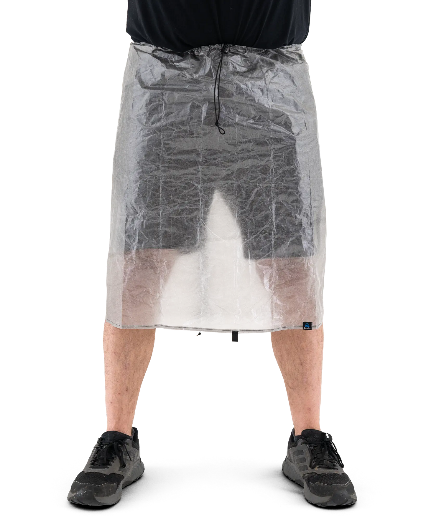 Zpacks DCF Rain Kilt DCFレインキルト 着用前面 - 腰から膝上を覆った状態。半透明のDCF越しに脚が透け、ウエストのドローコードが正面に垂れる（公式画像） - 山道具とULギアのお店 Ascend Lite