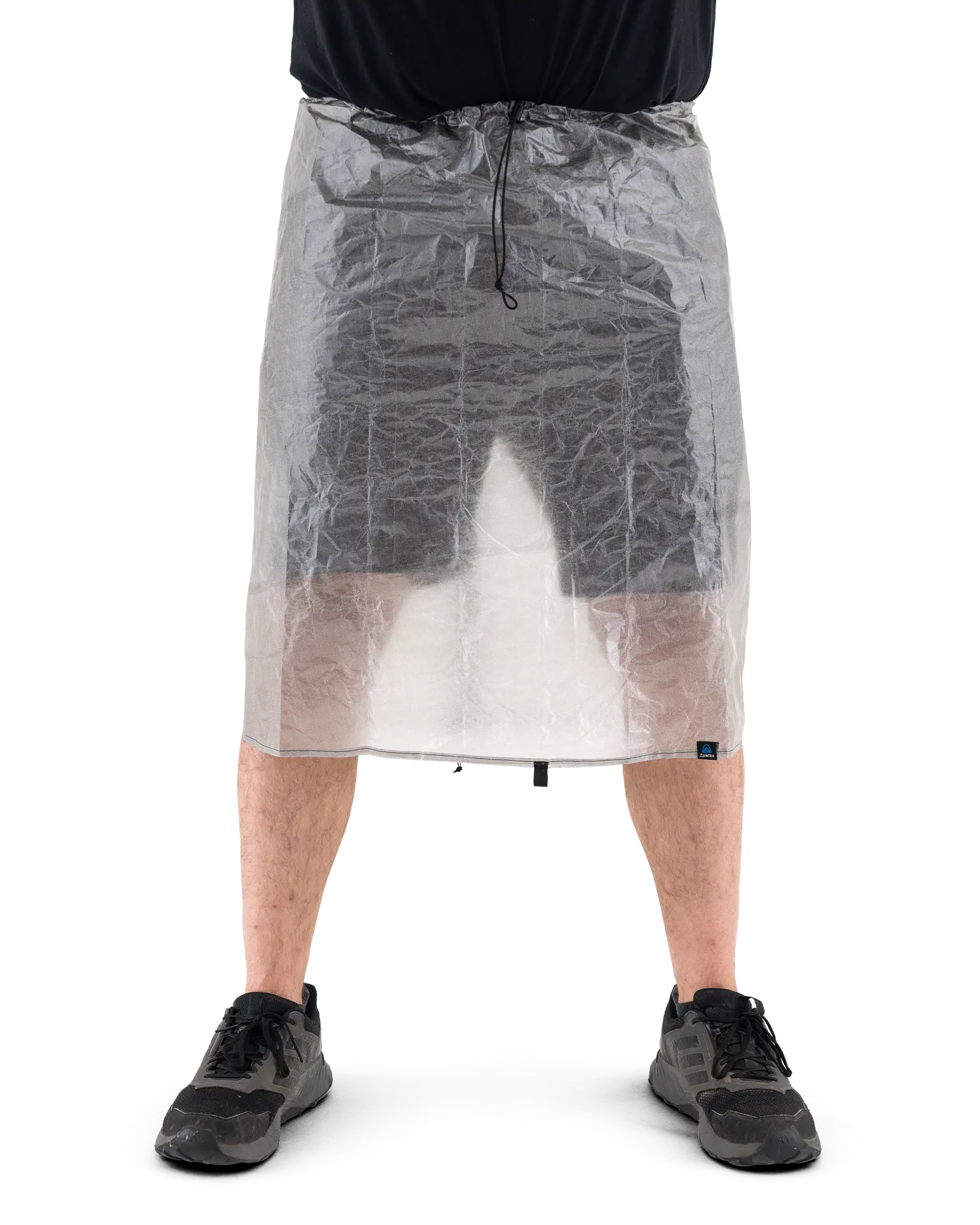 Zpacks DCF Rain Kilt DCFレインキルト 着用前面 - 腰から膝上を覆った状態。半透明のDCF越しに脚が透け、ウエストのドローコードが正面に垂れる（公式画像） - 山道具とULギアのお店 Ascend Lite
